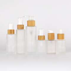 Frosted glass cosmetic bamboo cap bottle with spray glass pump bottles for cosmetics