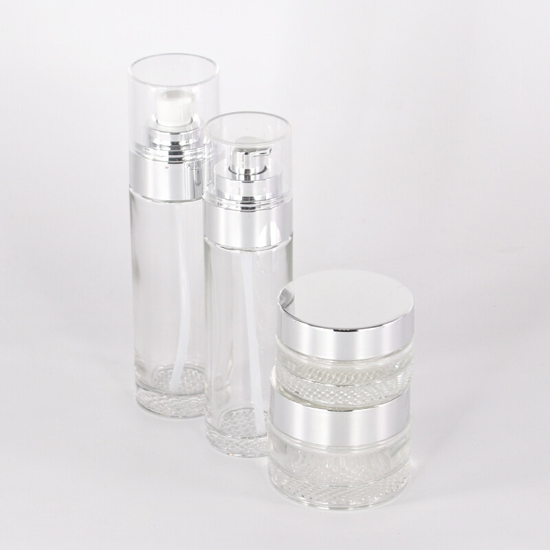 New design cosmetic packaging series clear glass bottle and jar with silver plating pump and cover
