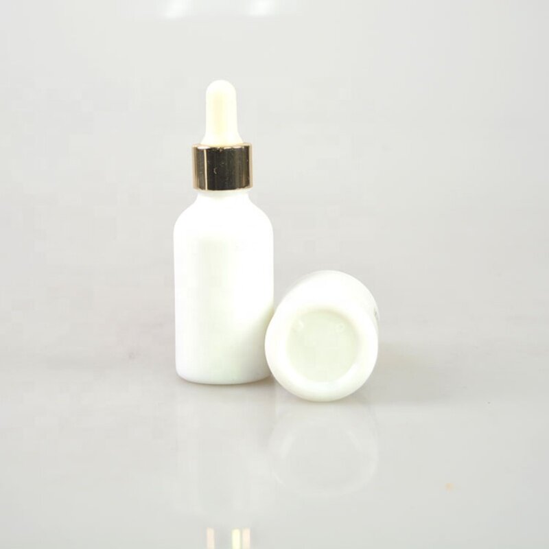 Opal white glass bottle with golden aluminum dropper for skin care