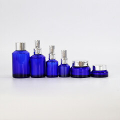 Wholesale blue glass essential oil bottles glass cream jars multi-size empty high quality cosmetic packaging