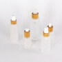 Wholesales 50ml bamboo lid glass bottle frosted glass lotion pump bottle with bamboo lid