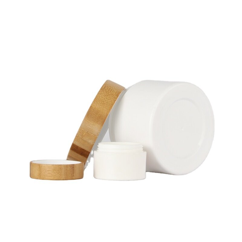 White plastic skincare packaging face cream jars with bamboo lid