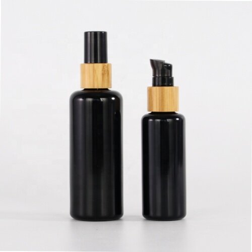Round shoulder black glass bottle for skin care package bamboo collar opaque black glass products with plastic lids