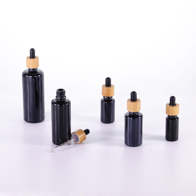 Wholesale Black Round Essential Oils Aromatherapy Glass Bottles With Bamboo Wooden Caps 5ml 10ml 15ml 20ml 30ml 50ml 60ml 100ml