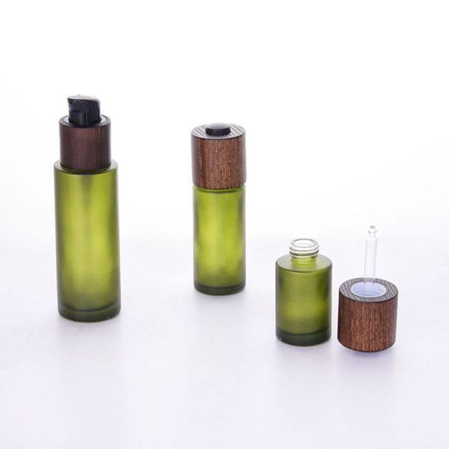 Customized color cosmetic packaging 30ml 50ml 100ml  flat shoulder frosted glass lotion bottle with ash tree wooden lid