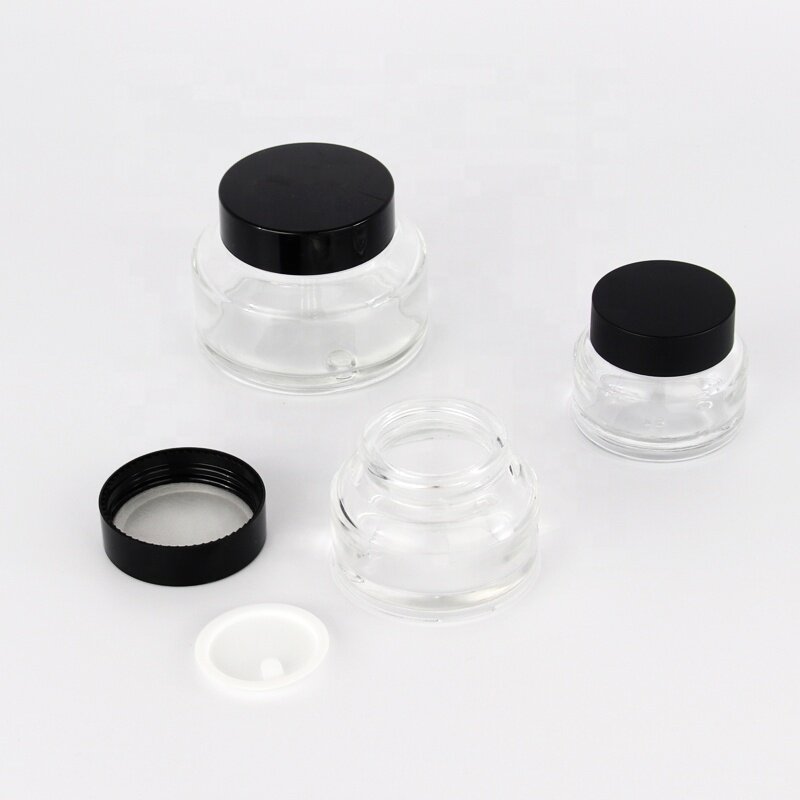 Clear glass bottles and jars with black plastic cap screw up