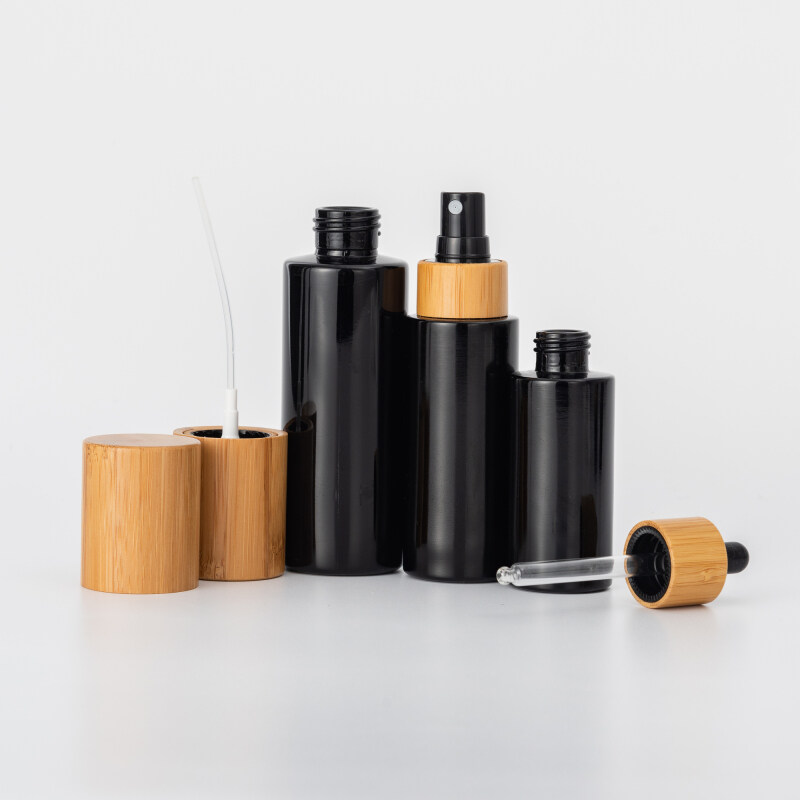 Cosmetic black glass pump bottles and cream jars with bamboo lid,dark violet glass bottle