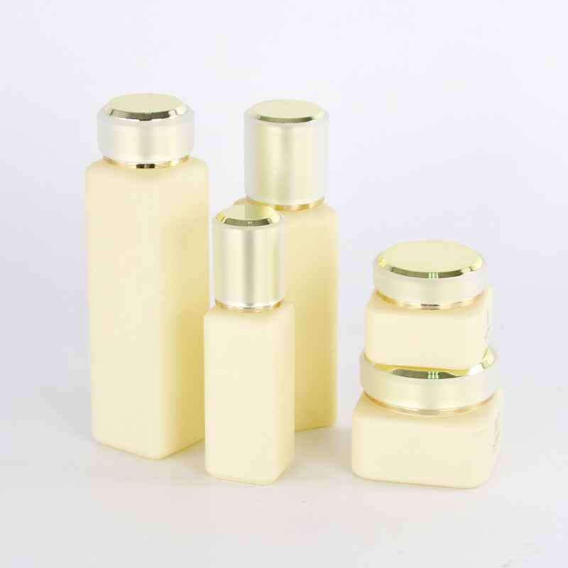 Wholesale luxury skin care body lotion 30ml 100ml 150ml matte yellow glass bottles cosmetic cream jars 30g 50g with golden caps