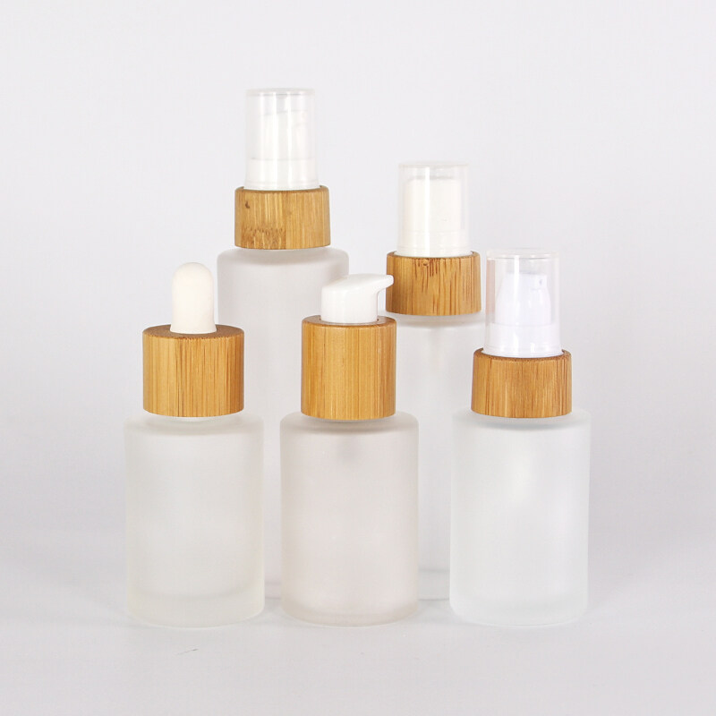 Wholesales 50ml bamboo lid glass bottle frosted glass lotion pump bottle with bamboo lid