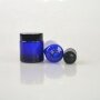 Blue cosmetic bottle with black plastic dropper for essential oil