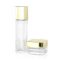 Clear cosmetic skincare glass lotion pump bottle and cream jar with gold screw top