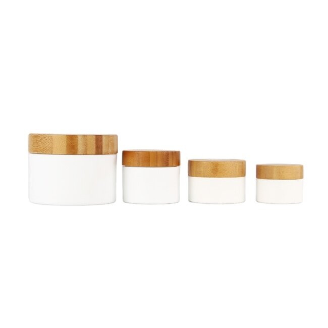 White plastic skincare packaging face cream jars with bamboo lid