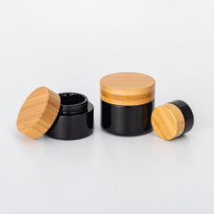 Cosmetic black glass pump bottles and cream jars with bamboo lid,dark violet glass bottle