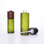 30ml 50ml 100ml high quality luxury green colored lotion bottles with wooden dropper and 30g 50g cream jar with wooden lid